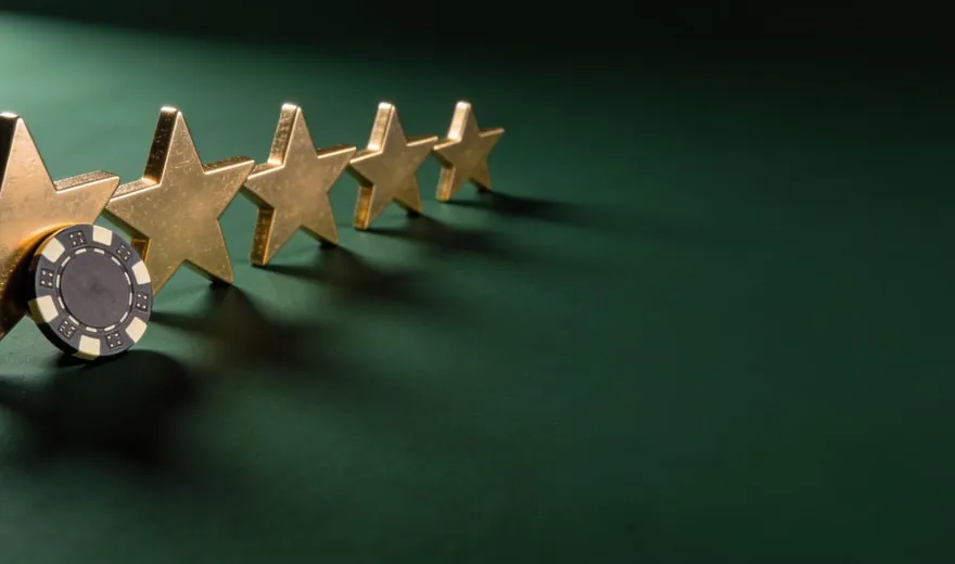 Gold stars and a casino chip on green baize