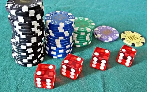 Red dice and casino chips on a table
